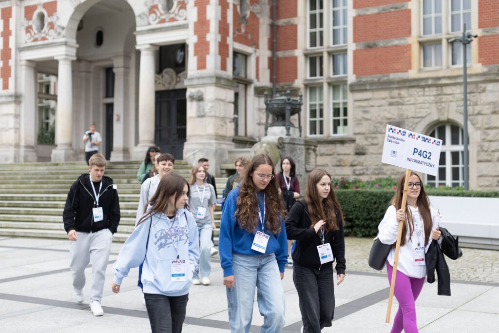 Zdjęcie przedstawia uczniów klasy III TI udających się pod opieką studenki PG na zajęcia w ramach panelu informatycznego